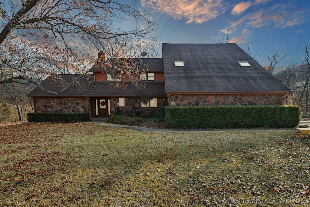 back house at dusk with a yard