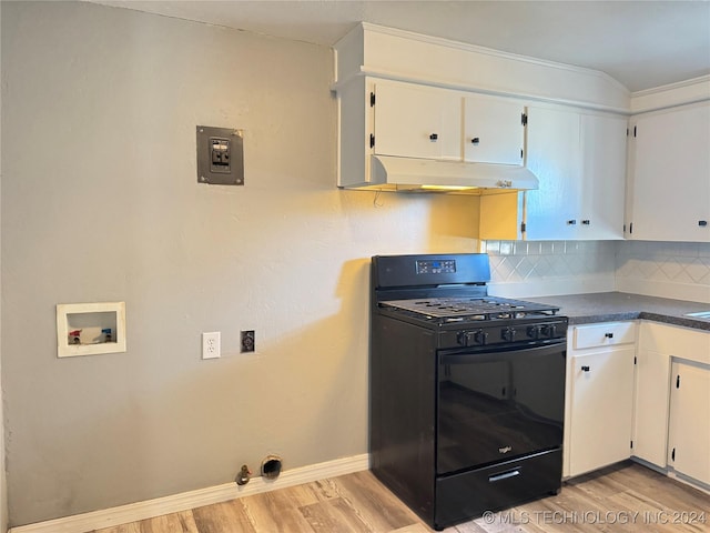 kitchen with decorative backsplash, black range with gas stovetop, and white cabinetry