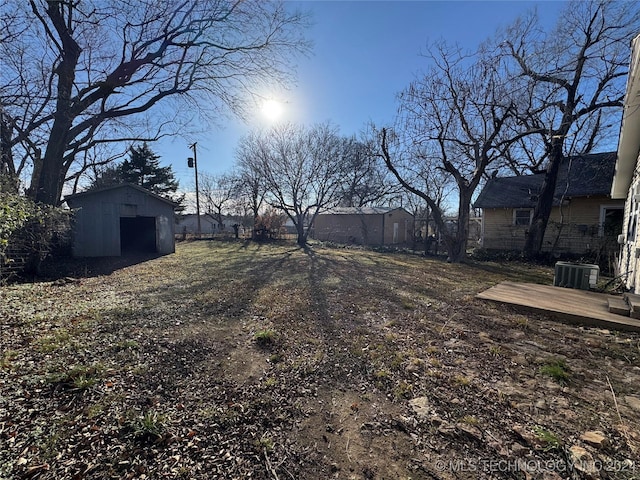 view of yard with cooling unit and a shed