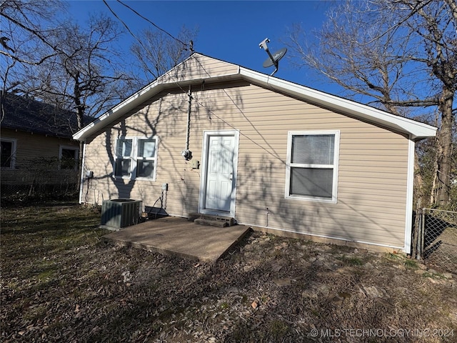 rear view of property featuring a patio area and central air condition unit