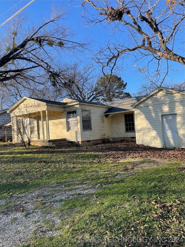 view of side of property with a yard