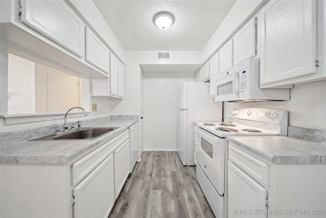 kitchen with a textured ceiling, white appliances, sink, light hardwood / wood-style floors, and white cabinetry