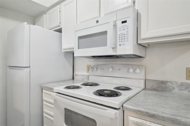 kitchen featuring white cabinets and white appliances