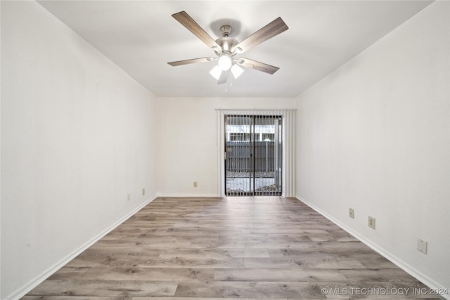 empty room with ceiling fan and light hardwood / wood-style flooring