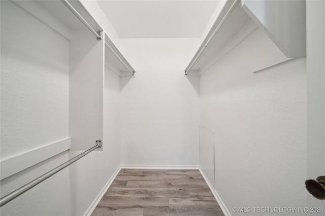 walk in closet featuring light hardwood / wood-style flooring