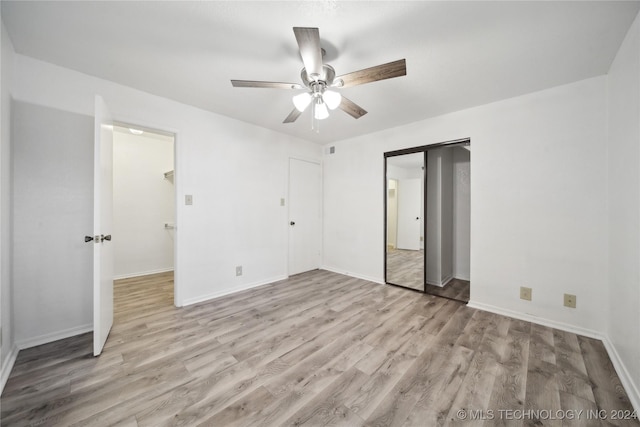 unfurnished bedroom with ceiling fan and light hardwood / wood-style flooring