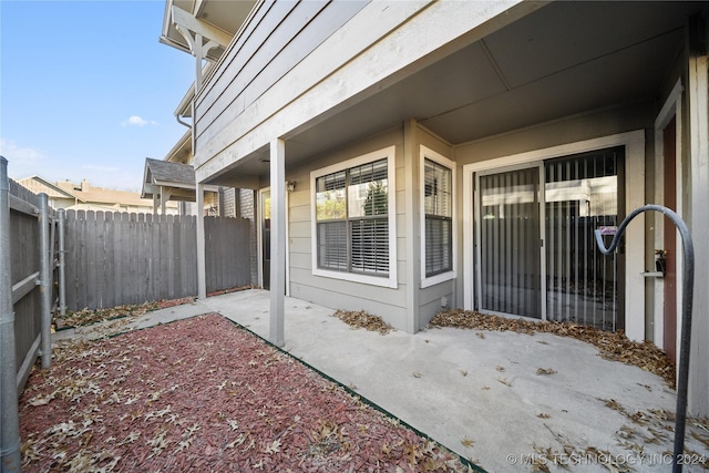 view of exterior entry with a patio