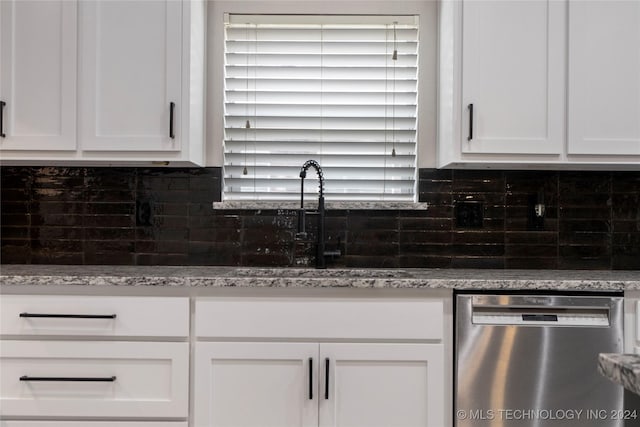 kitchen with dishwasher, white cabinets, sink, decorative backsplash, and light stone counters