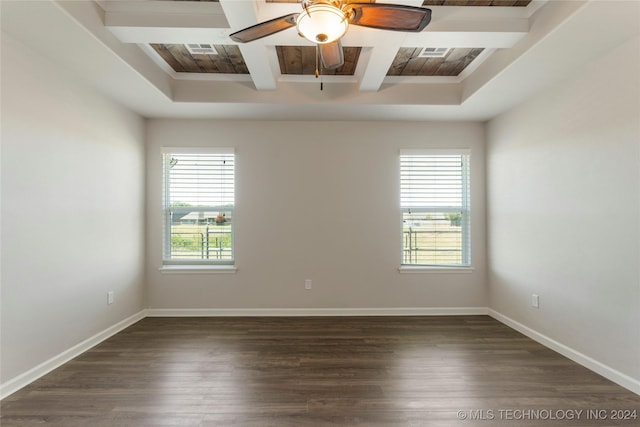 unfurnished room featuring beam ceiling, dark hardwood / wood-style flooring, plenty of natural light, and ceiling fan