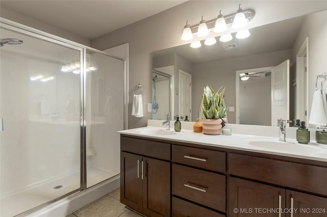 bathroom featuring tile patterned floors, ceiling fan, vanity, and a shower with shower door