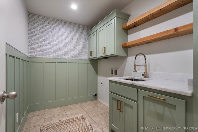 laundry area with electric dryer hookup, cabinets, sink, washer hookup, and light tile patterned floors