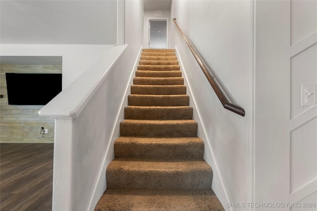 stairway with hardwood / wood-style floors