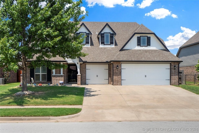 view of front of property with a garage and a front yard