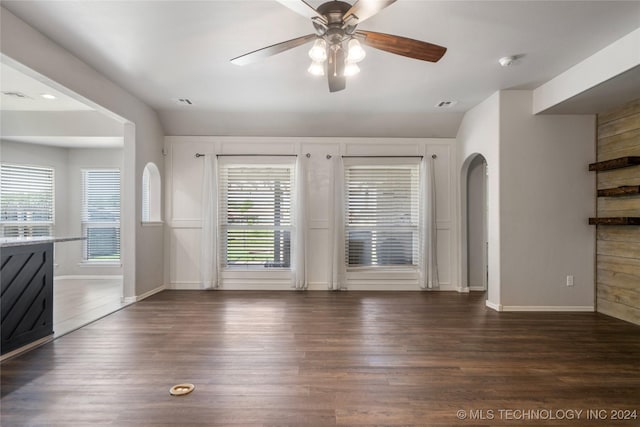 interior space with ceiling fan, dark wood-type flooring, and lofted ceiling