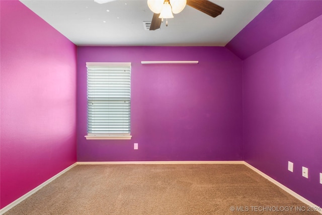 carpeted empty room with ceiling fan and lofted ceiling