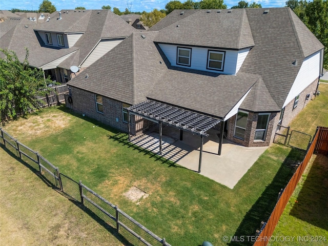 rear view of property with a lawn and a patio