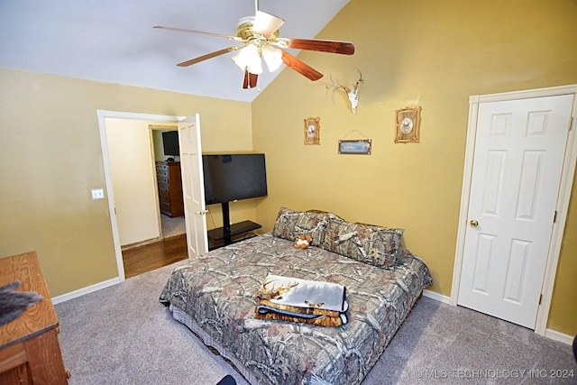 bedroom with dark colored carpet, vaulted ceiling, and ceiling fan