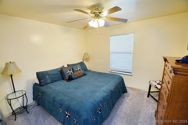 bedroom with ceiling fan and light carpet