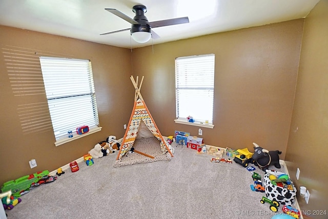 recreation room featuring carpet floors and ceiling fan