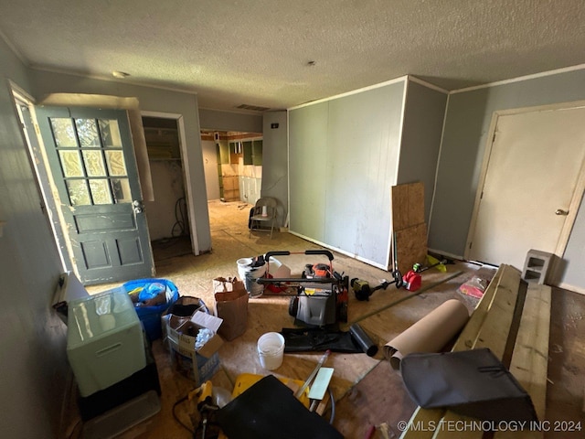 misc room featuring a textured ceiling and crown molding