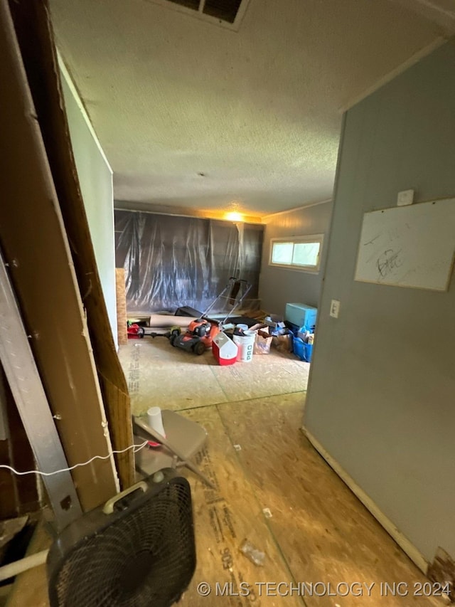 corridor with a textured ceiling