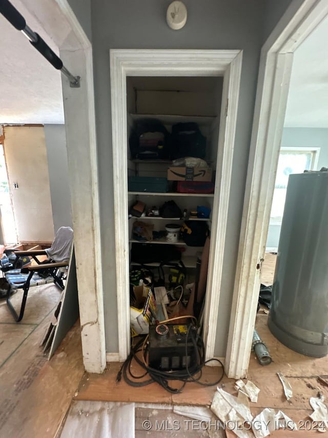 utility room featuring water heater