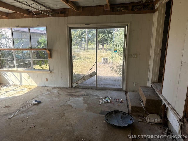 miscellaneous room with wood walls and plenty of natural light