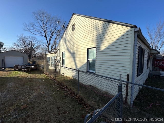 view of side of property with a garage and an outdoor structure