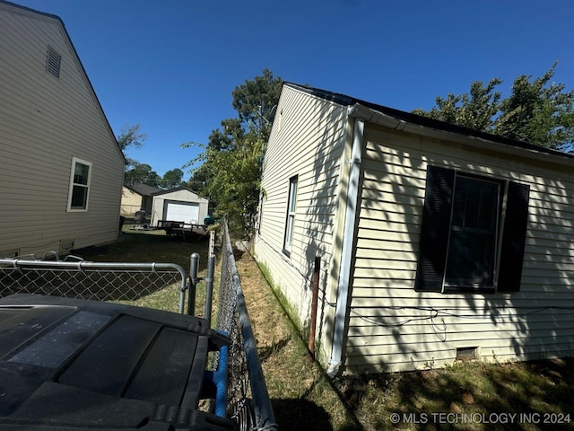 view of home's exterior with an outbuilding and a garage