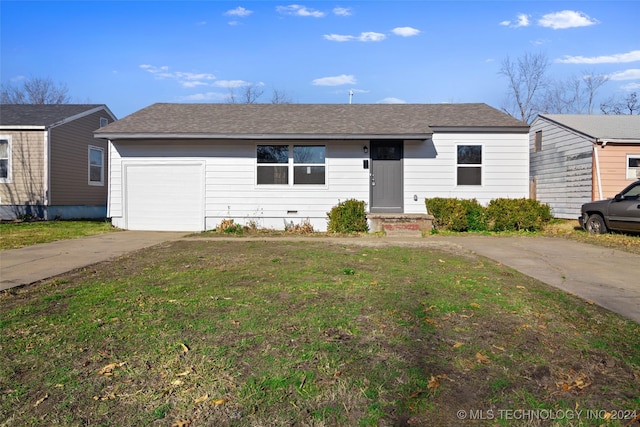 ranch-style house featuring a front lawn and a garage