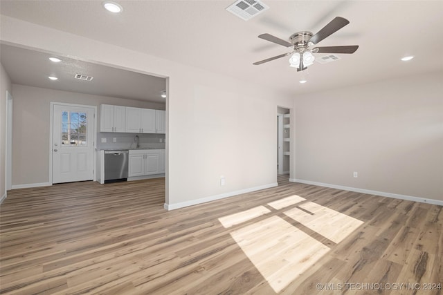 interior space with ceiling fan, light hardwood / wood-style flooring, and sink