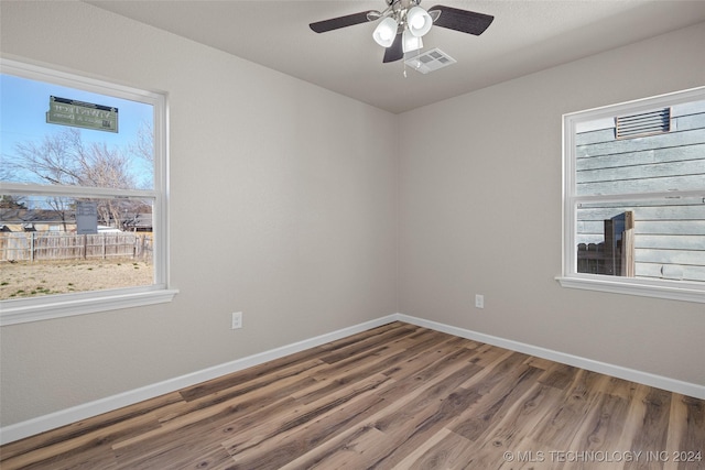 empty room with ceiling fan and wood-type flooring