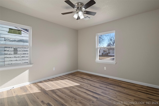 empty room with ceiling fan and wood-type flooring