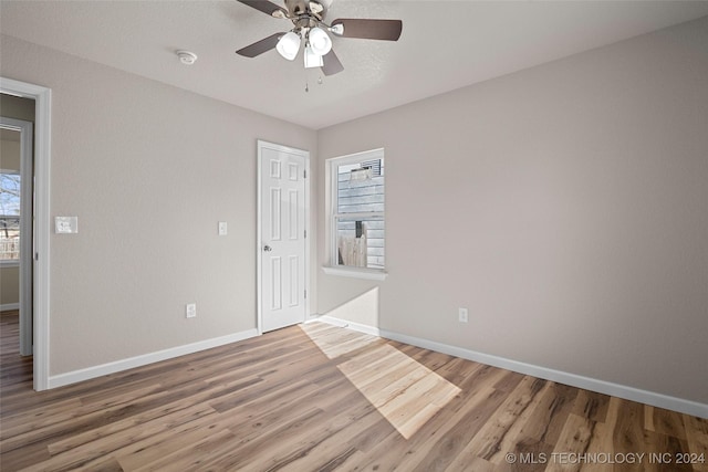 unfurnished room with hardwood / wood-style flooring and ceiling fan