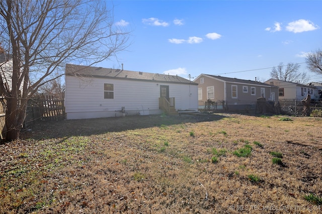 rear view of property featuring a yard