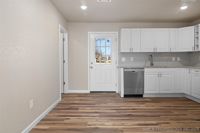 kitchen with backsplash, white cabinetry, dishwasher, and sink