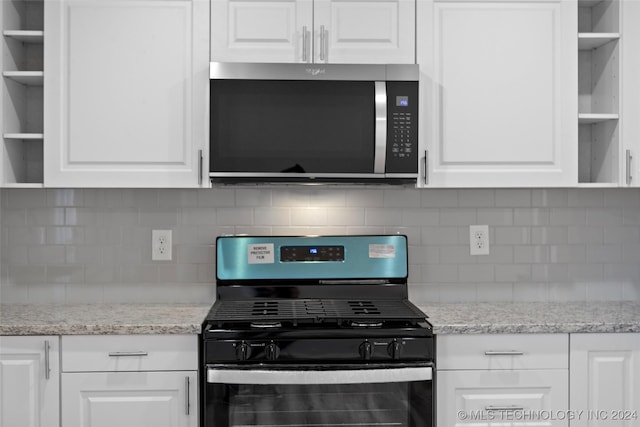 kitchen with white cabinetry, appliances with stainless steel finishes, and tasteful backsplash