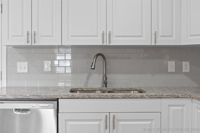 kitchen with dishwasher, white cabinets, and sink