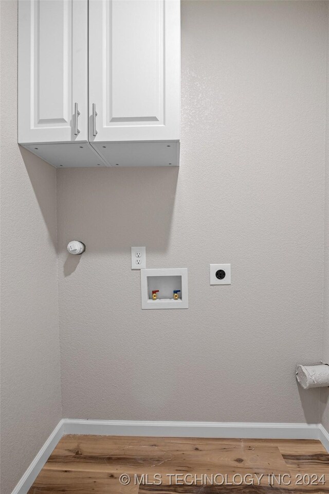 laundry area featuring washer hookup, hardwood / wood-style floors, cabinets, and hookup for an electric dryer