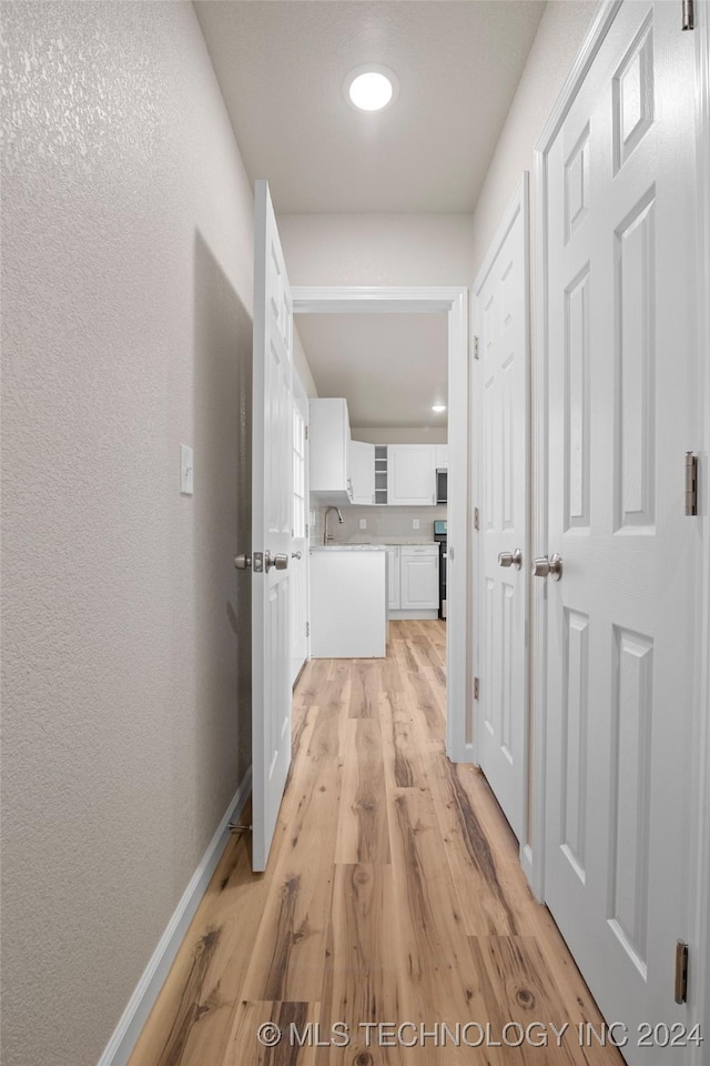 hall with light wood-type flooring