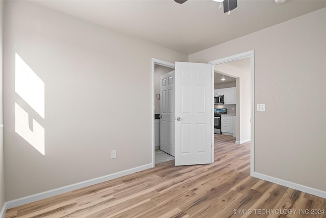 spare room with ceiling fan and light hardwood / wood-style flooring