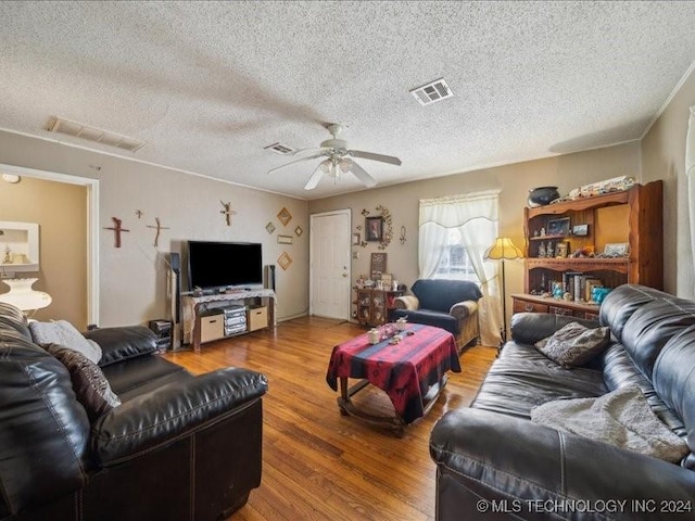 living room with wood-type flooring, a textured ceiling, and ceiling fan