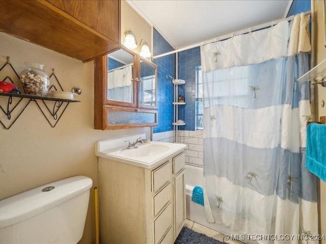 full bathroom featuring tile patterned floors, shower / bath combo with shower curtain, vanity, and toilet