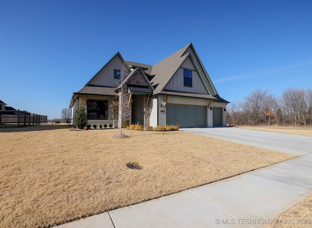 view of front of home featuring roof with shingles, a standing seam roof, concrete driveway, a garage, and metal roof