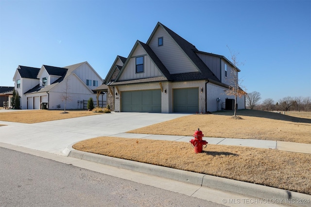 modern inspired farmhouse with board and batten siding, concrete driveway, an attached garage, roof with shingles, and brick siding