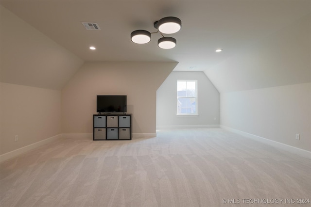 bonus room featuring light carpet and lofted ceiling