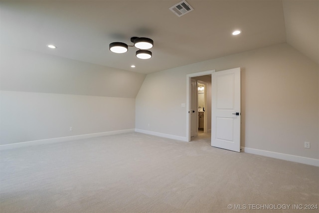 additional living space featuring baseboards, visible vents, lofted ceiling, recessed lighting, and light colored carpet