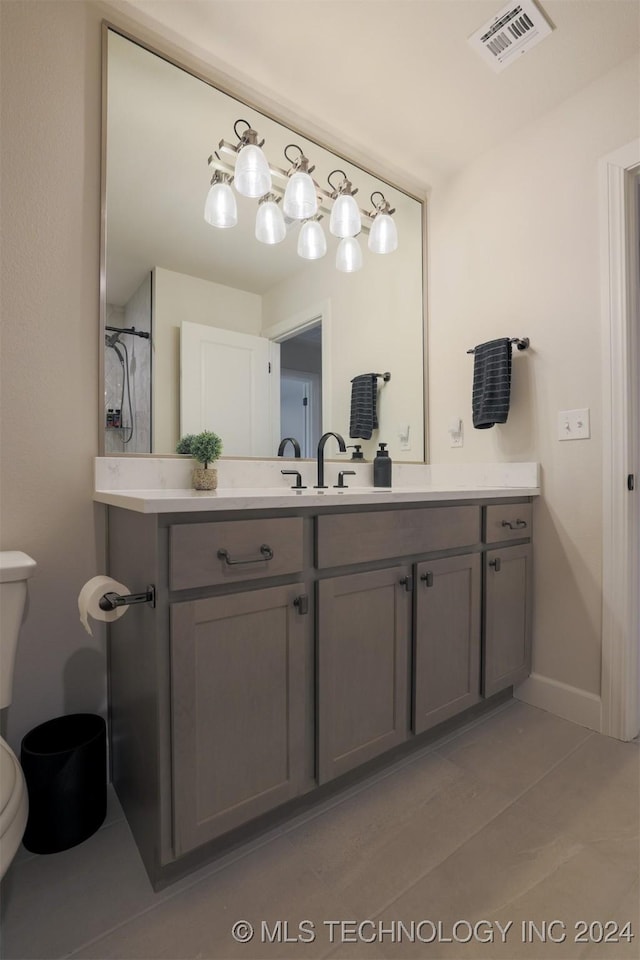 bathroom with tile patterned floors, visible vents, toilet, baseboards, and vanity