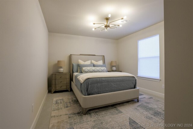 carpeted bedroom featuring an inviting chandelier