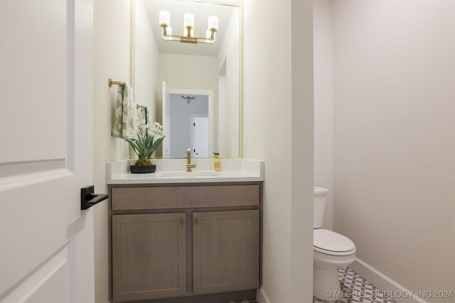 bathroom with tile patterned floors, vanity, and toilet